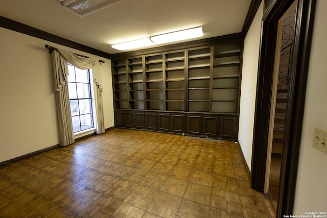 spare room with dark parquet floors and crown molding