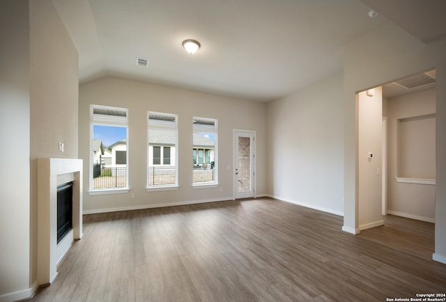 unfurnished living room with dark hardwood / wood-style floors and lofted ceiling