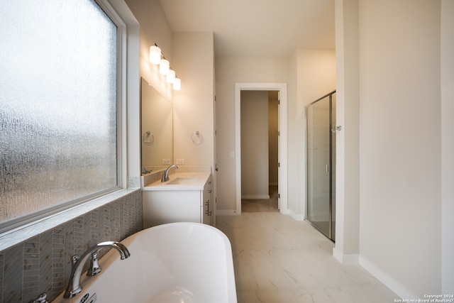 bathroom featuring vanity and shower with separate bathtub