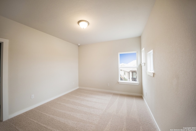 empty room featuring light carpet