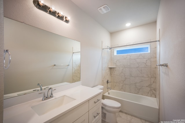 full bathroom featuring toilet, vanity, and tiled shower / bath