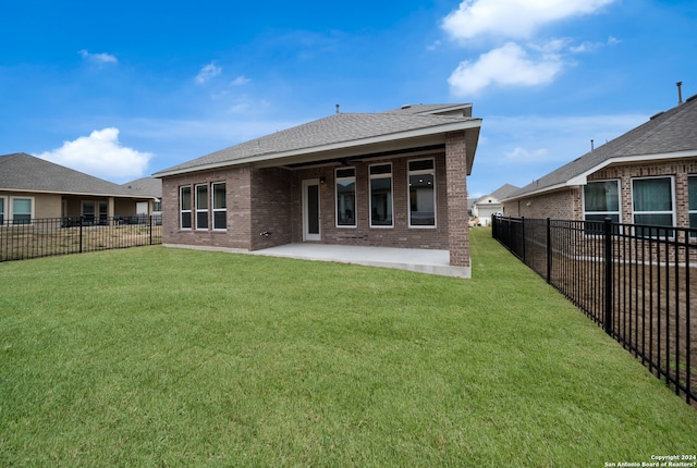 rear view of property featuring a yard and a patio