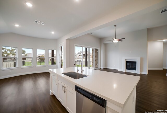 kitchen featuring white cabinetry, stainless steel dishwasher, dark hardwood / wood-style floors, an island with sink, and sink