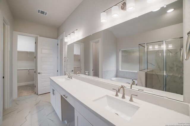 bathroom with separate shower and tub, dual sinks, tile floors, and oversized vanity