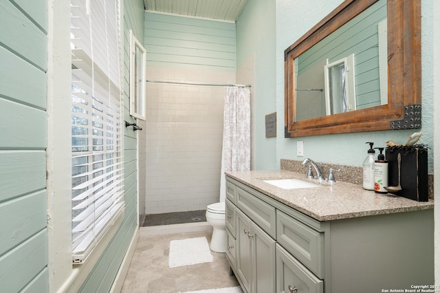 bathroom featuring toilet, plenty of natural light, vanity, a shower with curtain, and tile flooring