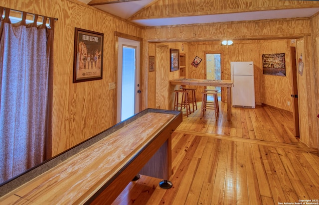 game room featuring wood walls and light wood-type flooring