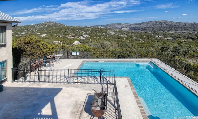 view of pool featuring a patio and a mountain view