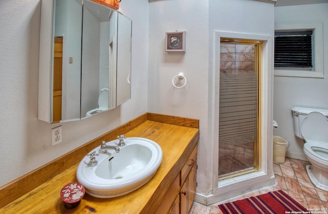 bathroom featuring tile flooring, toilet, and vanity with extensive cabinet space