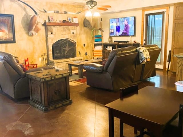 tiled living room featuring ceiling fan