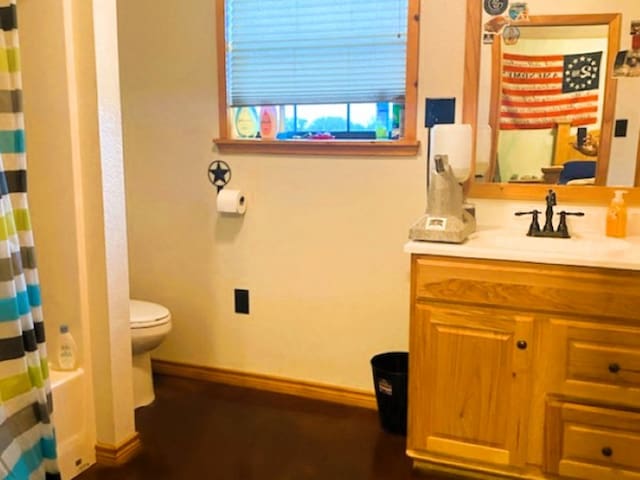 full bathroom with toilet, shower / tub combo, and vanity