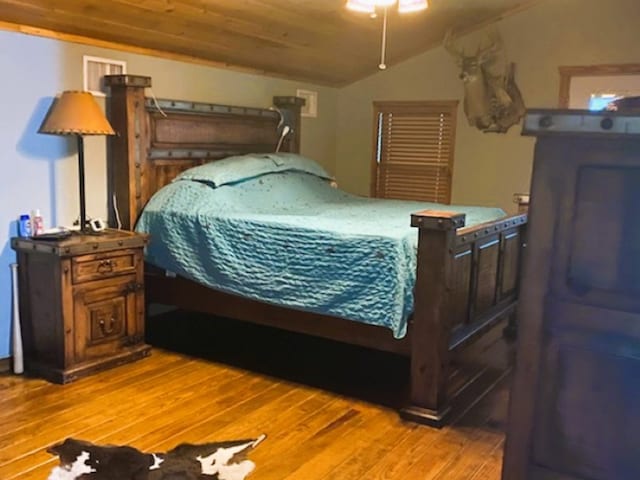 bedroom featuring lofted ceiling, wooden ceiling, and light hardwood / wood-style floors