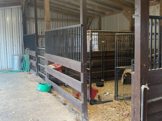 view of horse barn with an outdoor structure