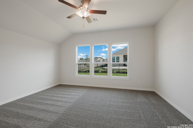 carpeted spare room featuring lofted ceiling and ceiling fan