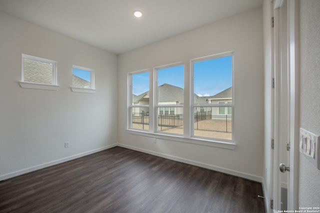 spare room featuring dark wood-type flooring