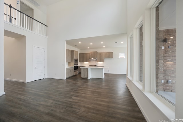 unfurnished living room with dark hardwood / wood-style flooring