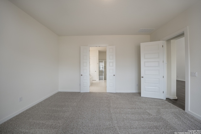 unfurnished bedroom featuring dark carpet