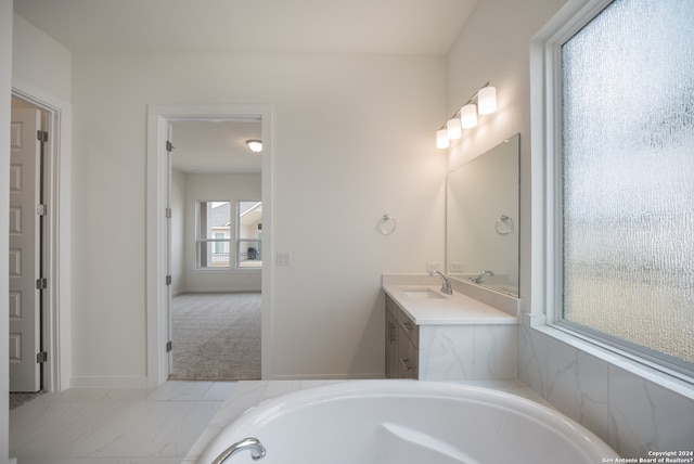 bathroom with a bath and vanity