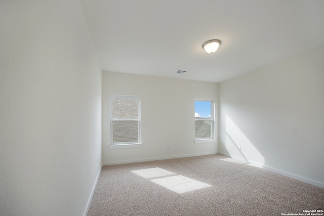 empty room featuring light colored carpet