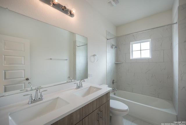 full bathroom with double sink vanity, toilet, tile flooring, and tiled shower / bath combo