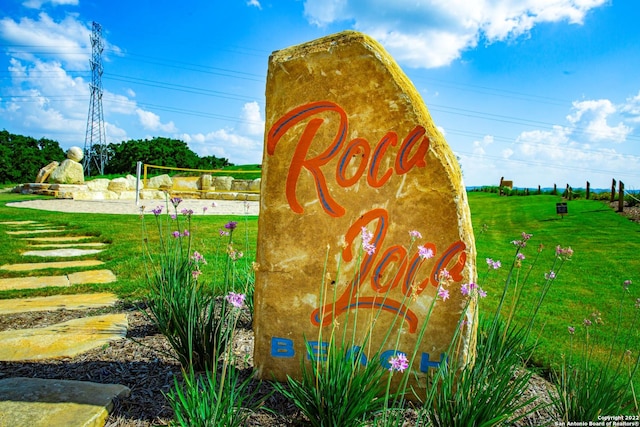 community sign featuring a lawn