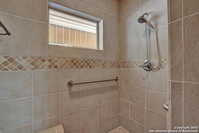 bathroom with tiled shower