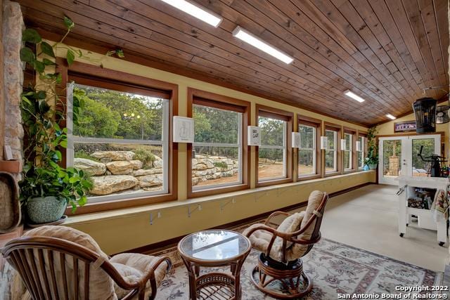 sunroom featuring vaulted ceiling, wood ceiling, and french doors