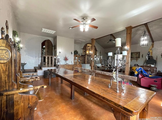 interior space with concrete flooring and ceiling fan with notable chandelier