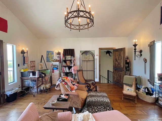 living room with an inviting chandelier, light hardwood / wood-style floors, and vaulted ceiling