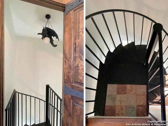 stairs with an inviting chandelier