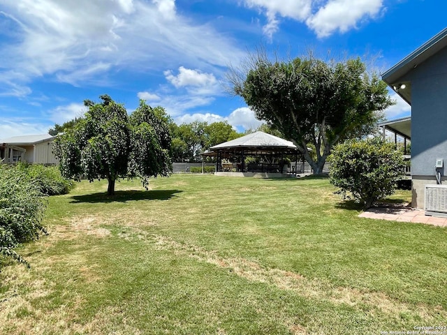 view of yard featuring a gazebo and central air condition unit