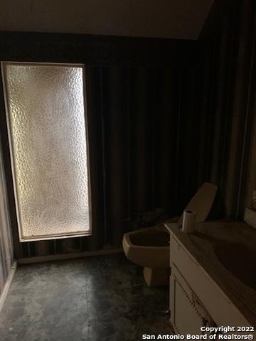 bathroom featuring tile flooring, toilet, and vanity