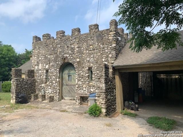 rear view of property featuring a garage