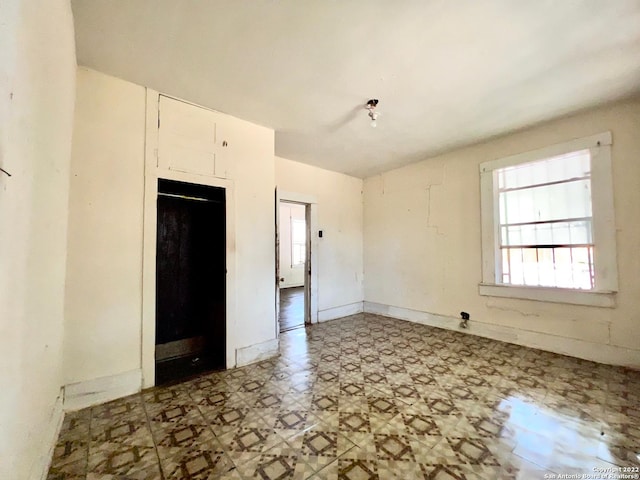 spare room with light tile floors