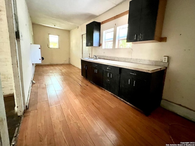 kitchen with light wood-type flooring and sink