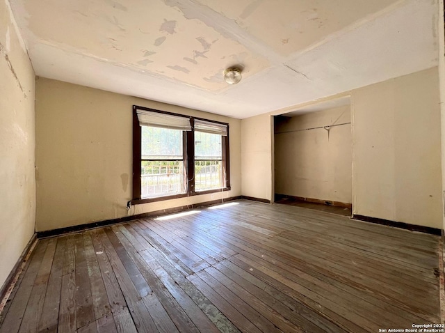 empty room with dark wood-type flooring