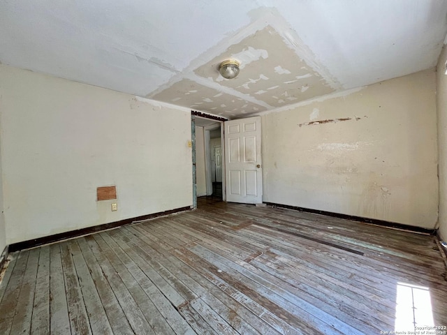 empty room with hardwood / wood-style flooring