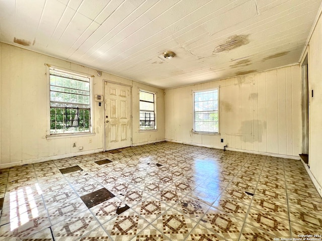 tiled spare room featuring a healthy amount of sunlight