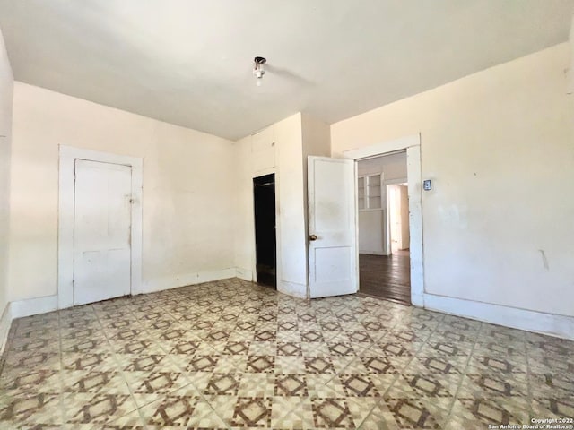 unfurnished bedroom with a closet and light tile flooring