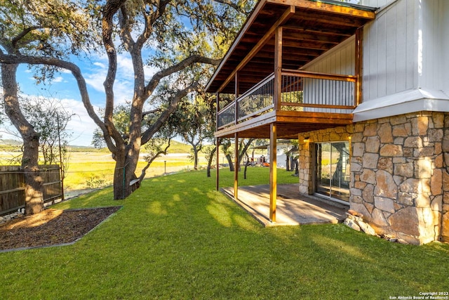 view of yard featuring a balcony and a patio area