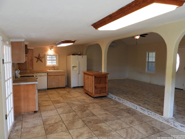 kitchen featuring white appliances, ceiling fan, sink, and light tile floors