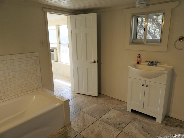 bathroom featuring a bath, vanity, and tile flooring