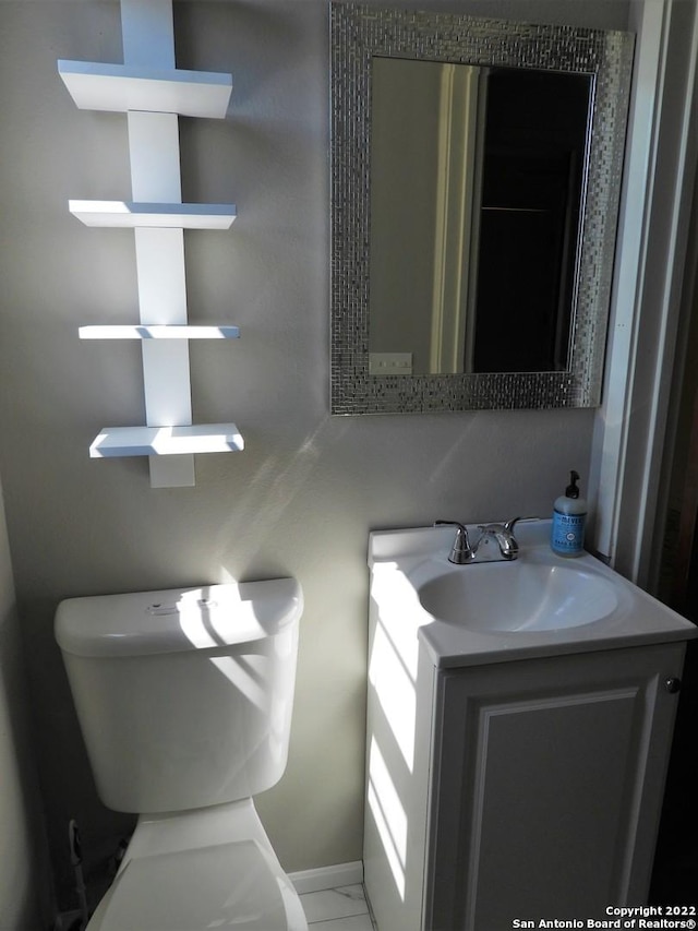 bathroom featuring toilet, tile flooring, and vanity