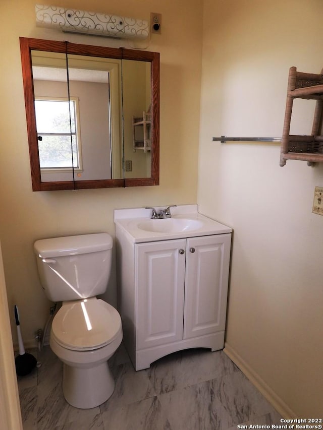 bathroom with tile floors, toilet, and vanity