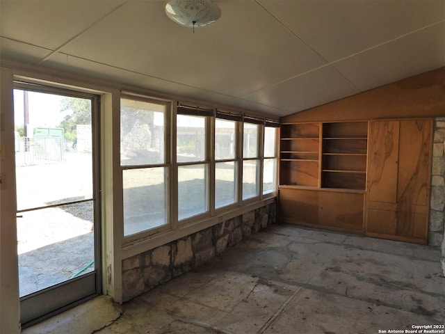 unfurnished sunroom featuring plenty of natural light and vaulted ceiling