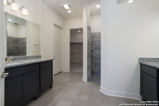 bathroom featuring tile floors and vanity