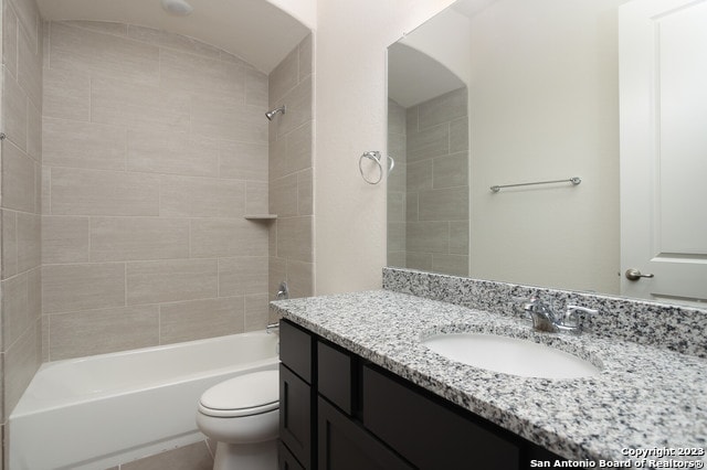 full bathroom with oversized vanity, toilet, and tiled shower / bath