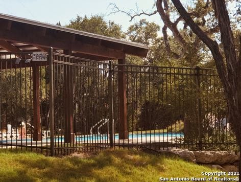 view of gate with a fenced in pool