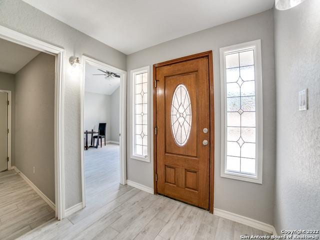 entryway with ceiling fan and light wood-type flooring