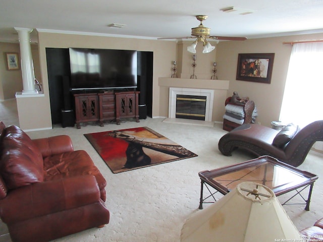 carpeted living room featuring ornate columns, ceiling fan, and ornamental molding