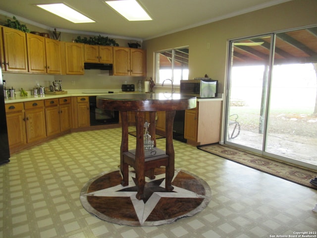 kitchen featuring light tile floors, crown molding, and wall oven